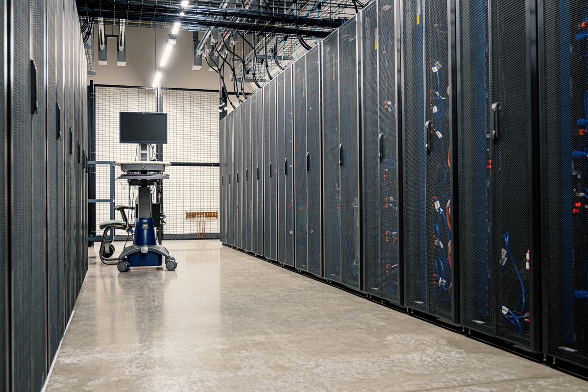 Aisle between server cabinets in a bright data hall