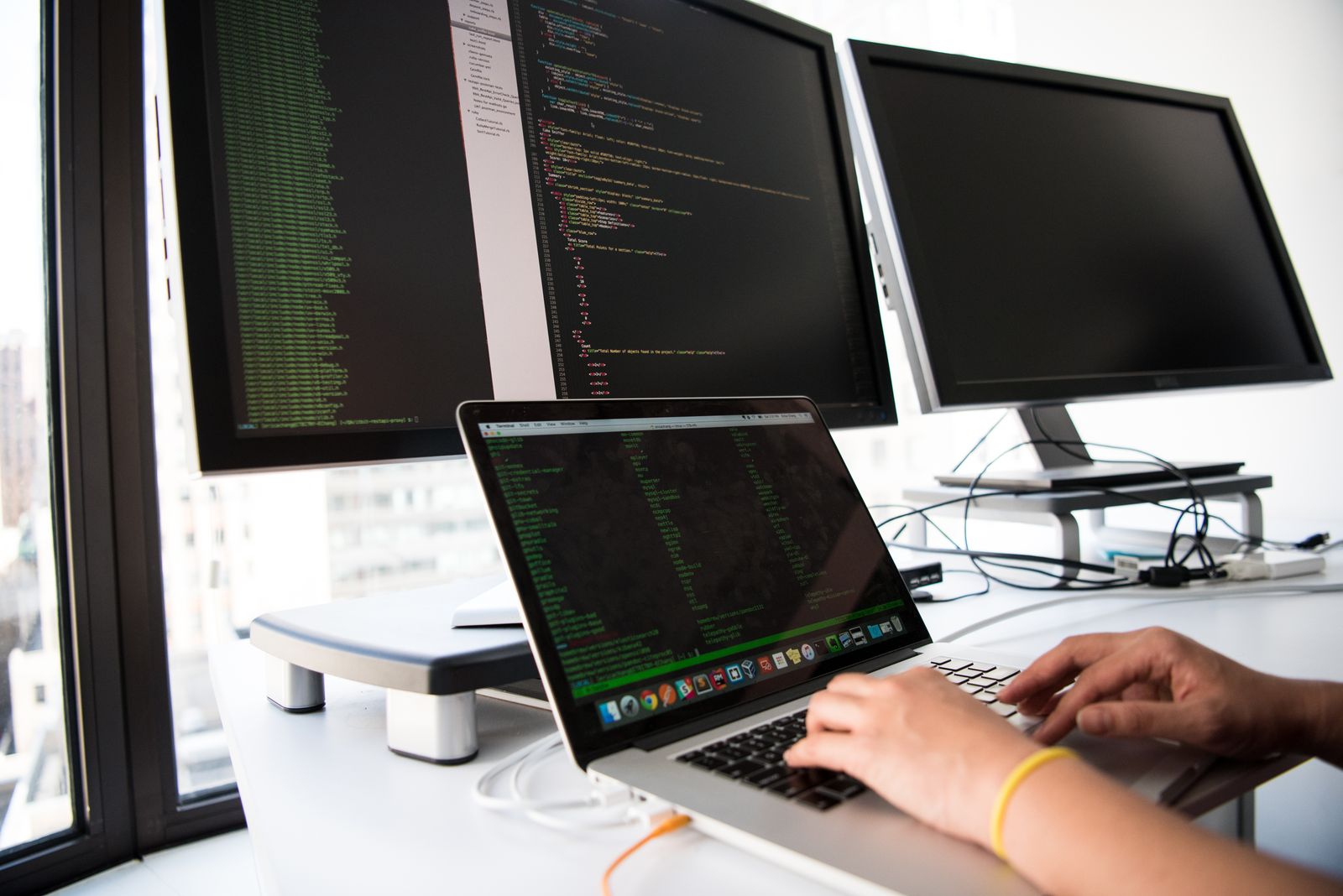 Woman working on website code on a laptop
