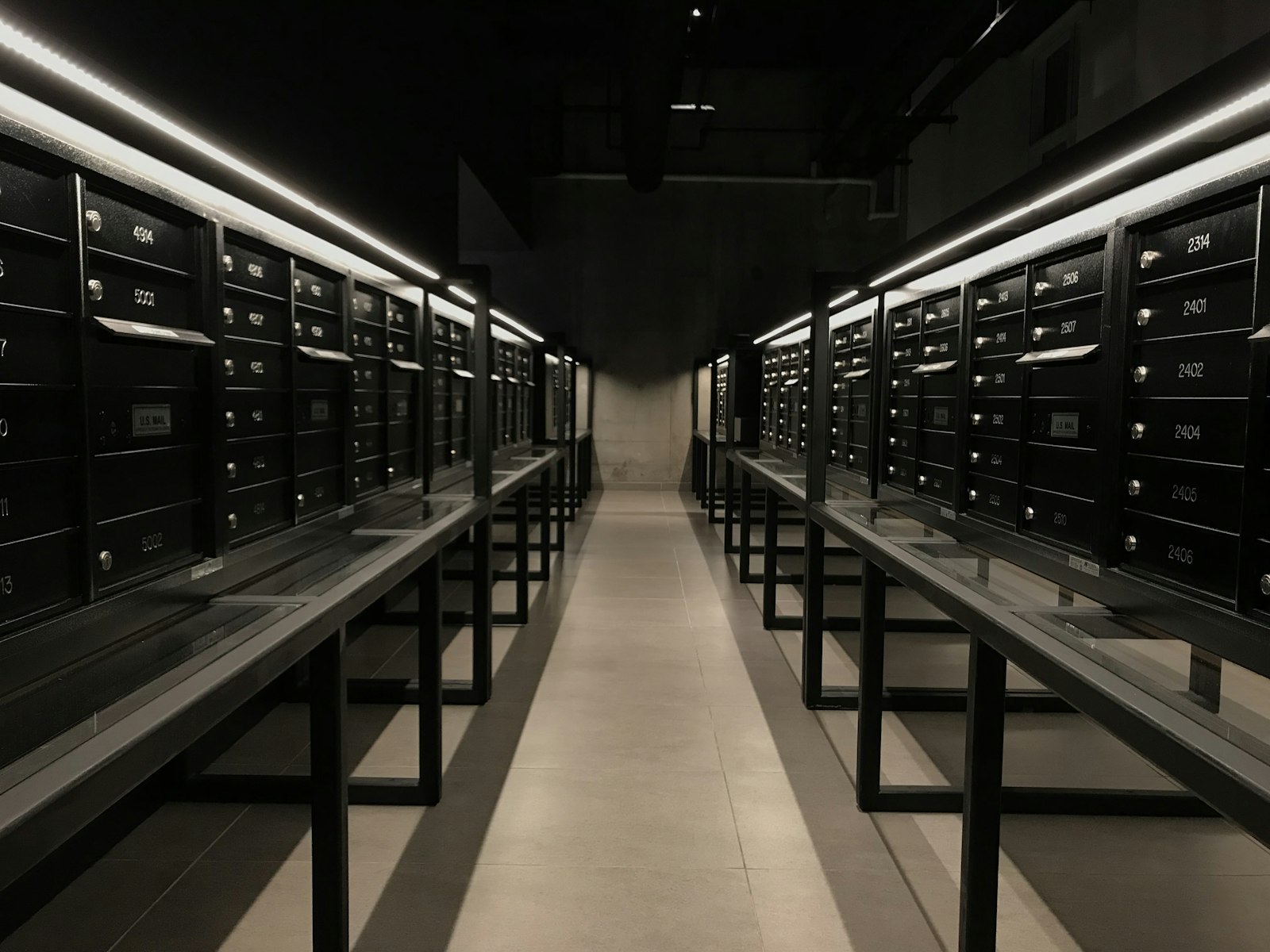 Long hall of servers in a dark data centre