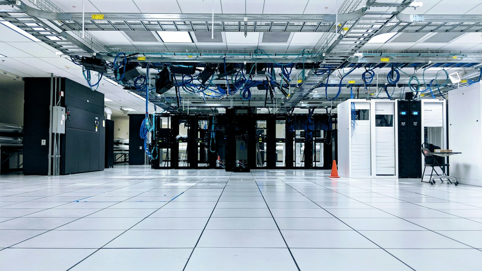 Bright, modern data centre floor with server racks