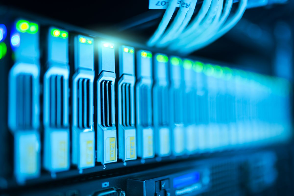 Rows of servers lit in blue inside a data centre