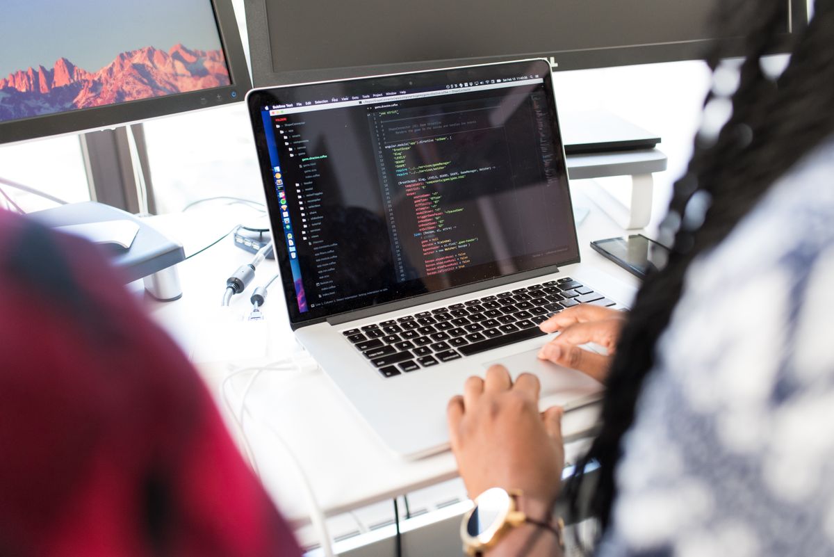Developer writing code on a laptop
